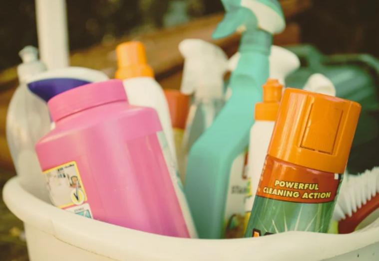 Various household cleaners inside a bucket